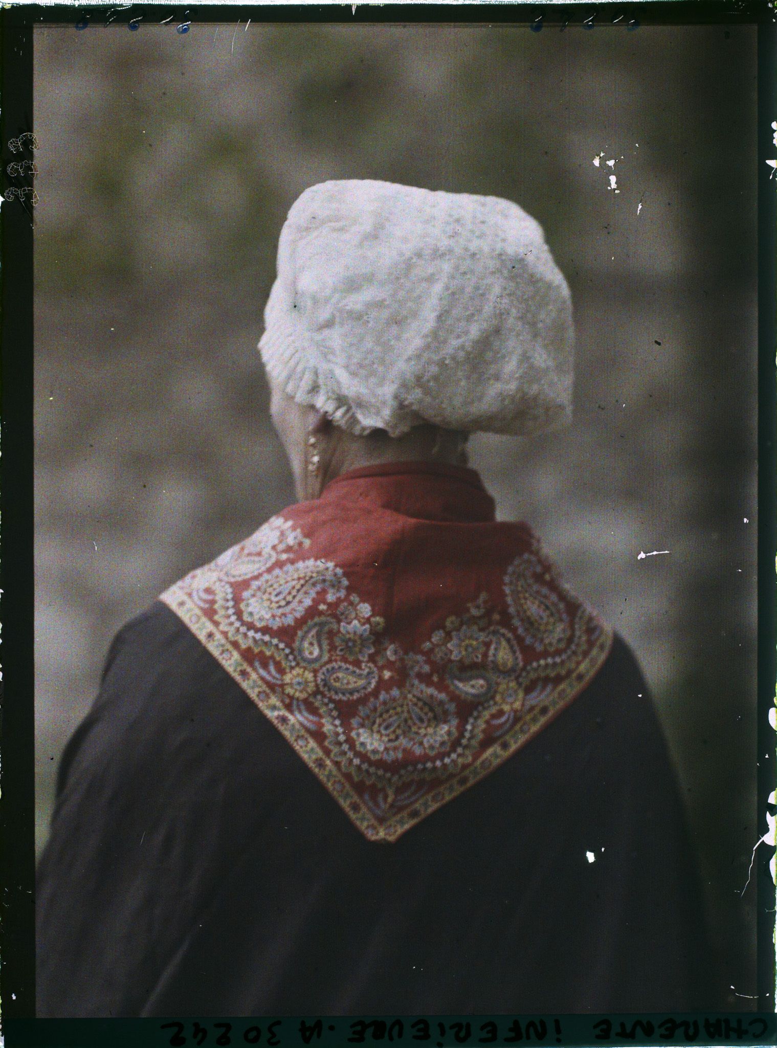 Image représentant Madame Bonnet portant la coiffe rochelaise, de dos