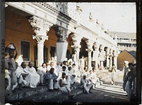 Image représentant Groupe d'hommes vêtus de blanc, assis sur les marches d'un temple hindou