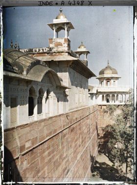 Image représentant Vue sur l'extérieur de l'enceinte du fort Rouge (Lal Qila), la toiture du palais privé (Khas Mahal) surmontée de chhatris et, au fond, la tour du Jasmin (Musamman Burj)