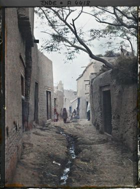 Image représentant Une rue : à l'arrière-plan, quelques passants