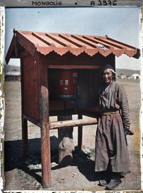 Image représentant Un lama devant un moulin à prières